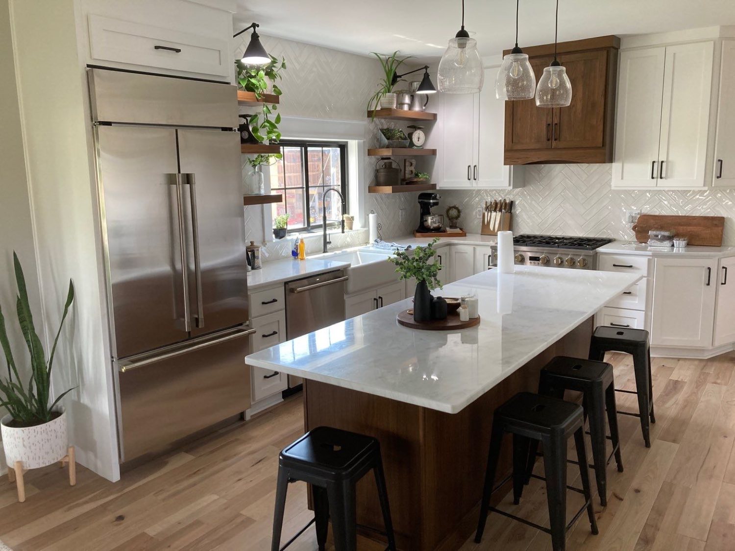 Finished open-plan kitchen remodel with white cabinetry and an island